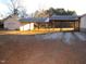 Exterior of the home highlighting the covered parking area and a garage with a driveway at 1200 Spring Valley Lake Rd, Henderson, NC 27536
