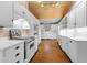 Charming white kitchen with wood ceiling, brick accent wall, and stainless steel appliances at 1200 Spring Valley Lake Rd, Henderson, NC 27536