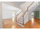 Open-concept living room with hardwood floors, staircase, and a chandelier, offering ample space at 1200 Spring Valley Lake Rd, Henderson, NC 27536
