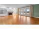 Bright living room with a fireplace, hardwood floors, and glass doors leading to the deck at 1200 Spring Valley Lake Rd, Henderson, NC 27536