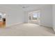 Large main bedroom featuring a bay window with backyard views and neutral carpet at 1200 Spring Valley Lake Rd, Henderson, NC 27536