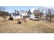 Back of house features a screened porch, deck, and landscaped yard at 1200 Spring Valley Lake Rd, Henderson, NC 27536
