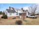 Rear exterior featuring a screened porch, deck, white siding, and brick foundation at 1200 Spring Valley Lake Rd, Henderson, NC 27536