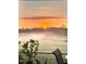 Beautiful sunrise over a lush green lawn, enhancing the property's scenic appeal at 1200 Spring Valley Lake Rd, Henderson, NC 27536