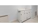 View of a utility sink in a neutral color with white cabinets at 1200 Spring Valley Lake Rd, Henderson, NC 27536