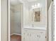 Clean bathroom with white vanity, mirror, and closet at 1225 Kilmory Dr, Cary, NC 27511
