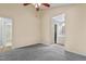 Well-lit bedroom with grey carpet, a ceiling fan and access to a full bathroom at 1225 Kilmory Dr, Cary, NC 27511