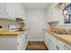 Efficient kitchen with white cabinets and wood countertops at 1225 Kilmory Dr, Cary, NC 27511