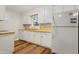 Galley kitchen featuring white cabinets and wood countertops at 1225 Kilmory Dr, Cary, NC 27511