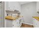 Small kitchen with white cabinets and wood countertops at 1225 Kilmory Dr, Cary, NC 27511