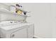 White Whirlpool washer and dryer set in laundry room with shelving at 1225 Kilmory Dr, Cary, NC 27511