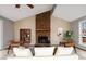 Living room with brick fireplace, hardwood floors, and stylish furniture at 1225 Kilmory Dr, Cary, NC 27511