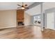 Bright living room with a brick fireplace, ceiling fan, wood floors and natural light at 1225 Kilmory Dr, Cary, NC 27511