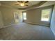 Spacious bedroom with carpet, large windows, and access to en-suite bathroom at 125 Hydrangea Ln, Benson, NC 27504