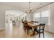 Open concept dining room with kitchen view, farmhouse table, and chandelier at 128 Curling Creek Dr, Clayton, NC 27527