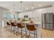 Modern kitchen with white cabinets, large island, and stainless steel appliances at 128 Curling Creek Dr, Clayton, NC 27527