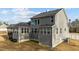 Back exterior featuring a screened porch, ample natural light, and a serene backyard setting at 128 S Clearbrook Ct, Angier, NC 27501