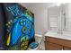 This bathroom showcases a vanity with mirror and whimsical shower curtain at 128 S Clearbrook Ct, Angier, NC 27501
