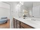 Bright bathroom features a double sink vanity with granite counters and a decorative flower arrangement at 128 S Clearbrook Ct, Angier, NC 27501