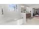 Bathroom with a tub to enjoy a relaxing bath. The window brings in natural light and a view of the outdoors at 128 S Clearbrook Ct, Angier, NC 27501