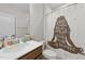 Light and bright bathroom features a modern sink, vanity, and a shower curtain with a calming theme at 128 S Clearbrook Ct, Angier, NC 27501