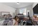 Bedroom is untidy, with a window view, desk setup, vanity, and a soft beanbag chair at 128 S Clearbrook Ct, Angier, NC 27501