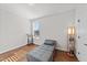 Cozy bedroom with a hardwood floor has a futon, natural light, and fresh white walls at 128 S Clearbrook Ct, Angier, NC 27501