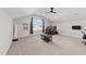 Spacious bonus room with a vaulted ceiling, ceiling fan, and large windows offers abundant natural light at 128 S Clearbrook Ct, Angier, NC 27501
