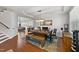 Bright dining area with hardwood floors, modern chandelier, and a spacious wooden table at 128 S Clearbrook Ct, Angier, NC 27501