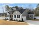 Well-maintained home featuring a two-car garage, stone accents, and professionally landscaped front yard at 128 S Clearbrook Ct, Angier, NC 27501
