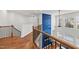 Upstairs landing showcases a bright blue decorative wall and railing overlooking the fireplace at 128 S Clearbrook Ct, Angier, NC 27501