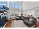 Cozy living room with a fireplace and large windows, complete with a comfortable gray sectional at 128 S Clearbrook Ct, Angier, NC 27501