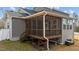 Lovely screened-in porch with wooden stairs and a gray exterior at 128 S Clearbrook Ct, Angier, NC 27501