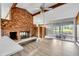 Living room with brick fireplace and large window at 1307 Shamrock Dr, Burlington, NC 27215