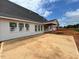 A concrete patio is accessible from the back of the home, with large windows along the back wall at 132 Tennyson Dr, Garner, NC 27529