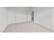Spacious bedroom with two doors and carpeted floor at 132 Tennyson Dr, Garner, NC 27529