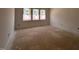 A bedroom with three windows providing ample natural light before carpet installation at 132 Tennyson Dr, Garner, NC 27529