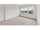 Well-lit bedroom featuring three windows and carpet at 132 Tennyson Dr, Garner, NC 27529