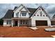 New construction shows a charming home with a three car garage and craftsman style details at 132 Tennyson Dr, Garner, NC 27529