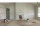Large living room with a fireplace, bright natural light, and an open layout at 132 Tennyson Dr, Garner, NC 27529