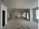 Open-concept living space with large windows and a fireplace, flooded with natural light at 132 Tennyson Dr, Garner, NC 27529