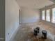 Spacious living room with a charming archway and plentiful windows to let light in at 132 Tennyson Dr, Garner, NC 27529