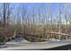 Stone patio with fireplace and pergola, aerial view at 148 Hidden Creek Ct, Pittsboro, NC 27312