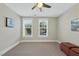 Bright bedroom with two windows, ceiling fan, and neutral carpeting at 148 Hidden Creek Ct, Pittsboro, NC 27312