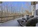 Relaxing deck with wooded views, comfortable seating and outdoor grill at 148 Hidden Creek Ct, Pittsboro, NC 27312