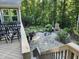 Deck overlooking patio, fire pit, and wooded area at 148 Hidden Creek Ct, Pittsboro, NC 27312
