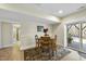 Bright basement dining area with wooden table and chairs near sliding glass doors at 148 Hidden Creek Ct, Pittsboro, NC 27312