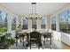 Bright dining room features a large table, chandelier, and hardwood floors at 148 Hidden Creek Ct, Pittsboro, NC 27312