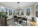 Sunlit dining room with a rustic wooden table and chandelier at 148 Hidden Creek Ct, Pittsboro, NC 27312