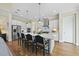 Bright kitchen boasts white cabinets, large island with seating, and stainless steel appliances at 148 Hidden Creek Ct, Pittsboro, NC 27312